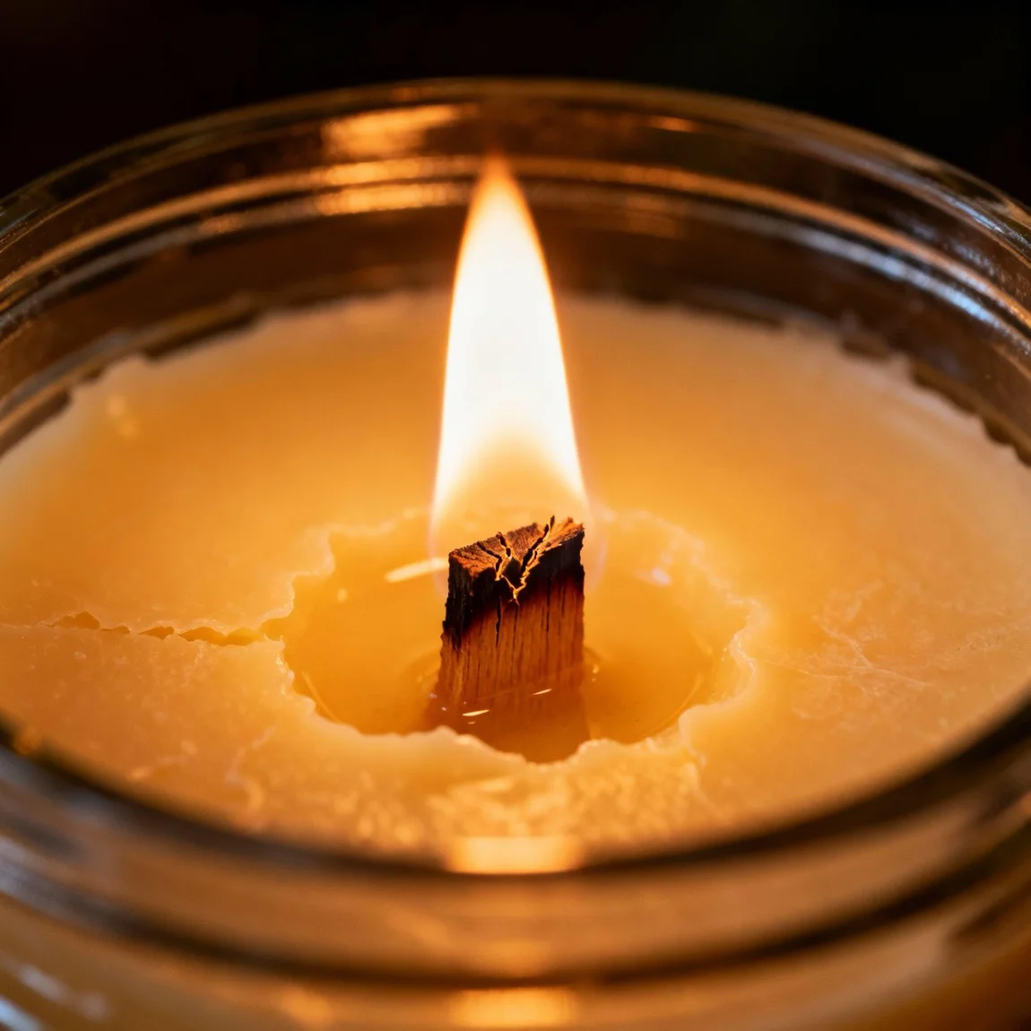 This is an extreme close-up macro shot focused on the texture of the wax and the detail of the lit wick. - ai product photography