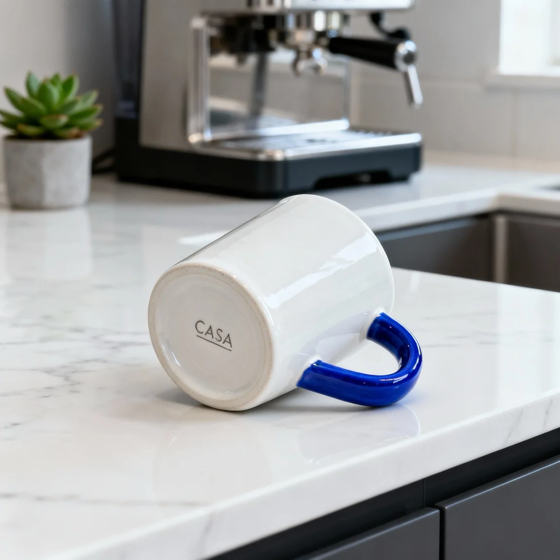 A stylish handmade mug is featured in a clean, modern kitchen setting on a marble countertop. - product photography ai